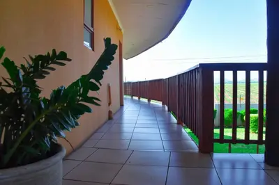 a hallway of a house with a balcony with a plant at Riverview Inn in Malelane