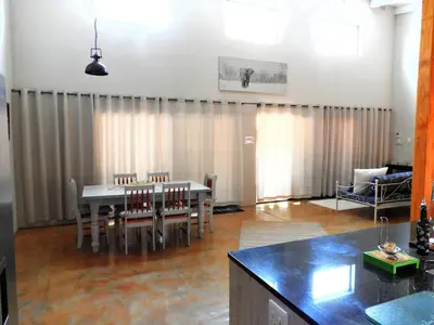 a living room with a table and chairs at Flight of the Eagle @ Kruger in Marloth Park