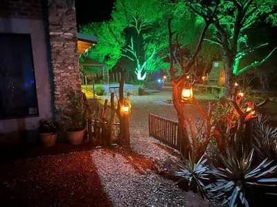 a garden at night with lights on a fence at Flight of the Eagle @ Kruger in Marloth Park
