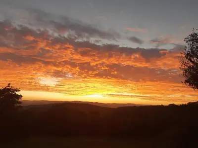 a sunset with the sun setting in the sky at Wild Fig Guesthouse in White River