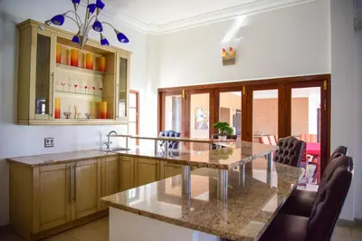 a kitchen with a table and chairs in a room at Indlovukazi Guesthouse in Hartbeespoort