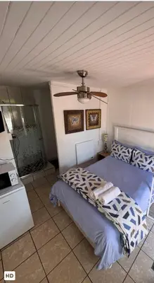 a bedroom with a bed and a ceiling fan at CenturionSleep&Go in Centurion