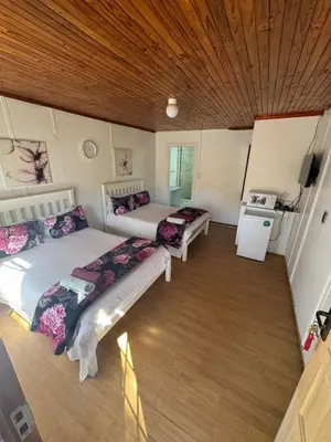 a room with two beds and a stove in it at CenturionSleep&Go in Centurion