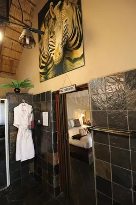a room with a room with a room with a bed at African Rock Lodge in Hoedspruit