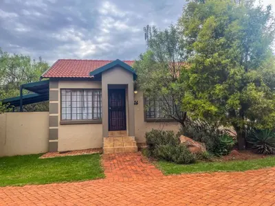 a small house with a red roof at Leribisi Lodge in Tierpoort