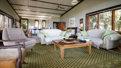 a living room with two couches and a coffee table at Tree Tops Guest Farm in Isidule