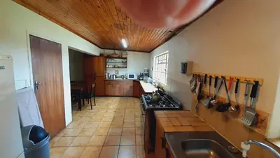 a kitchen with a sink and a counter top at Tree Tops Guest Farm in Isidule