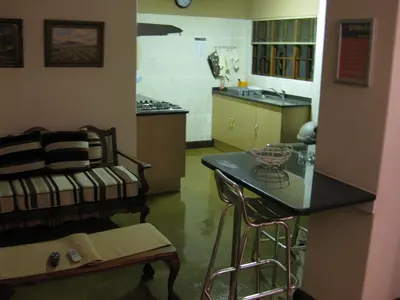 a kitchen with a counter and a table in a room at The Highveld Cape Inn in Pretoria