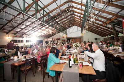 a group of people sitting at tables in a restaurant at The Highveld Cape Inn in Pretoria