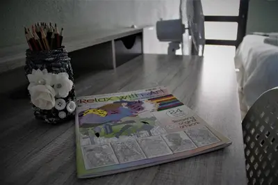 a childrens book on a table with a vase of flowers at Serendipity NO TV in Polokwane