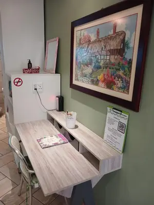 a desk in a room with a painting on the wall at Serendipity NO TV in Polokwane