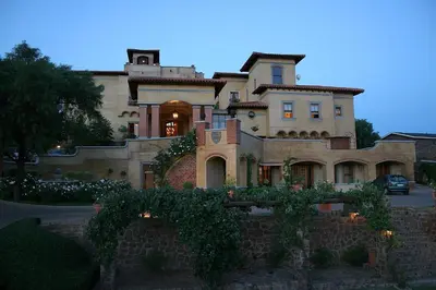 a large house with a brick wall at Castello Di Monte in Pretoria