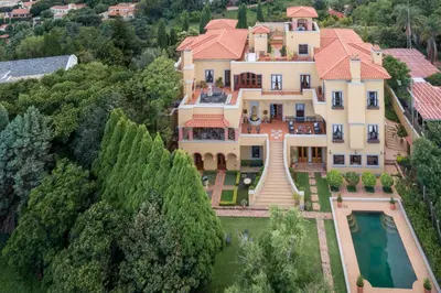 an aerial view of a house with a pool at Castello Di Monte in Pretoria