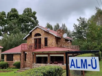 a house with a sign in front of it at Alm-Ü in Dullstroom