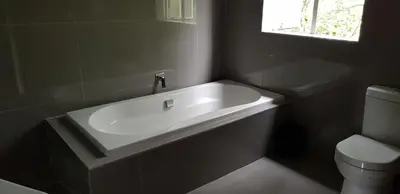a bathroom with a white sink and a toilet at Alm-Ü in Dullstroom
