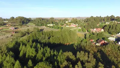 an aerial view of a town with trees and houses at Misty Cottage in Dullstroom