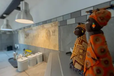 a room with a counter with a statue of a woman at African Sky Villas in Marloth Park
