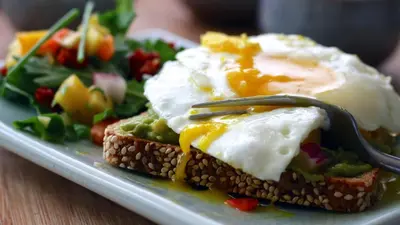 a plate of food with an egg and a salad at African Sky Villas in Marloth Park