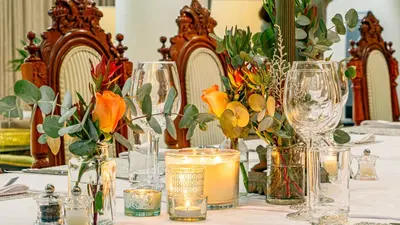 a table with several glass vases and flowers on it at Christies at 32 on Russell in Nelspruit