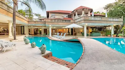 an image of a house with a swimming pool at Christies at 32 on Russell in Nelspruit