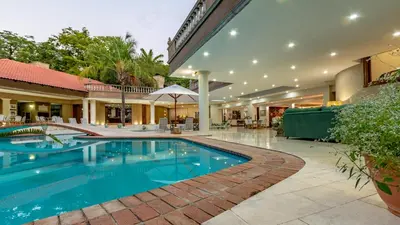 a swimming pool in the middle of a building at Christies at 32 on Russell in Nelspruit