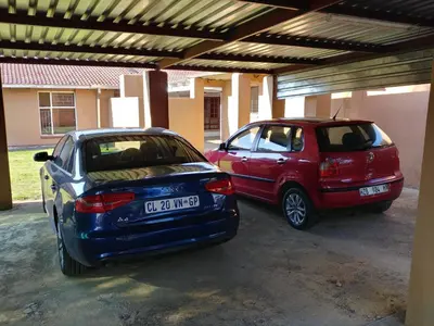 two cars parked next to each other in a garage at 22 on Nicol in Secunda