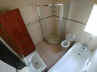 a bathroom with a shower and a toilet and a sink at 22 on Nicol in Secunda