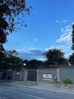 a building with a sign on the side of a street at Dreamwood Guest House in Nelspruit