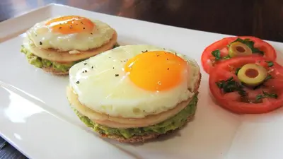 a plate of food with an egg and tomatoes at Ubuntu Bed and Breakfast in Marloth Park