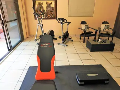 a gym with exercise bikes and a treadmill at Ubuntu Bed and Breakfast in Marloth Park