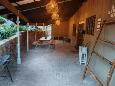 a patio with a table and a table at Arend Cottage in Nelspruit