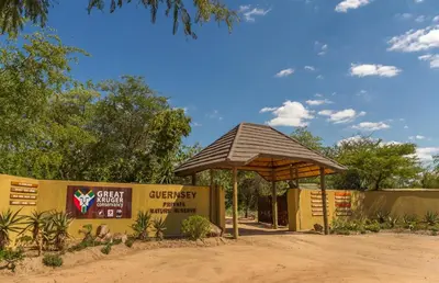 a pavilion at the entrance to a zoo with a sign at Panzi Lodge in Guernsey Nature Reserve
