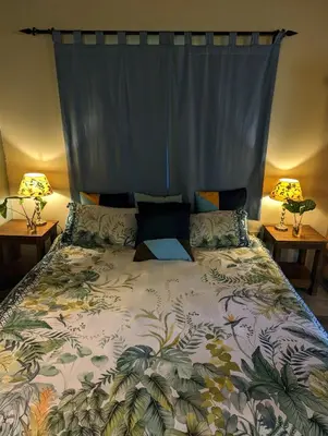 a bedroom with a large bed with two lamps at Hasekamp Hospitality in Hoedspruit