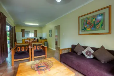 a living room with a couch and a table at Merry Pebbles Resort in Sabie