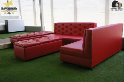 two red chairs and a couch in a room at Savannah Guest House in Polokwane