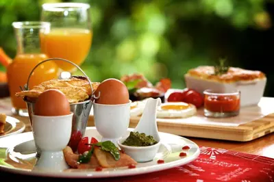 a table with a plate of eggs and other food at Christie's Inn in Tzaneen