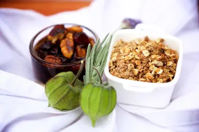 a bowl of granola next to a bowl of nuts at Christie's Inn in Tzaneen