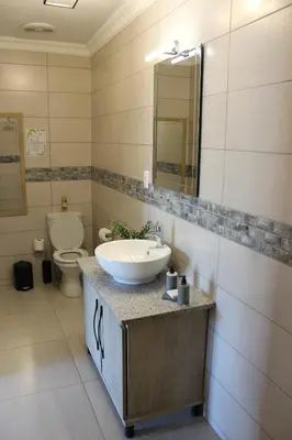 a bathroom with a sink and a toilet at Christie's Inn in Tzaneen