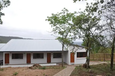 a white house with a metal roof at Hazyview Buffalo Game Lodge in Hazyview