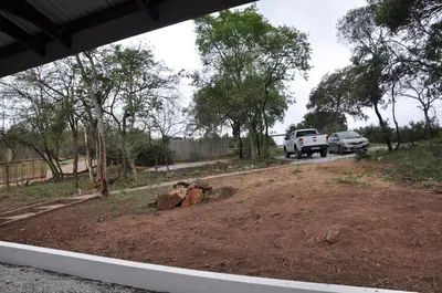 a truck parked on a dirt road with trees at Hazyview Buffalo Game Lodge in Hazyview