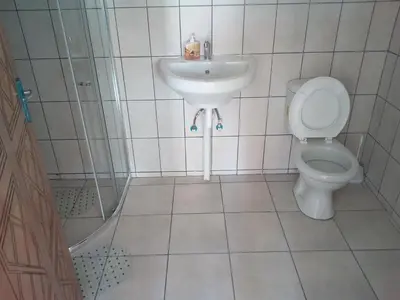 a bathroom with a toilet and a sink at Hazyview Buffalo Game Lodge in Hazyview