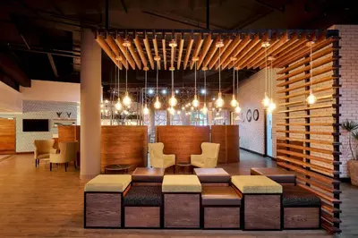 a lobby with a waiting room with chairs and a table at Protea Hotel by Marriott Pretoria Loftus Park in Pretoria