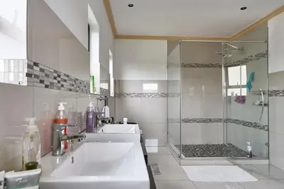 a bathroom with a sink and a shower at Alimama Spaces: Manson Mansion in Randjesfontein