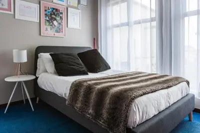 a bedroom with a bed with a blanket on it at Alimama Spaces: Manson Mansion in Randjesfontein