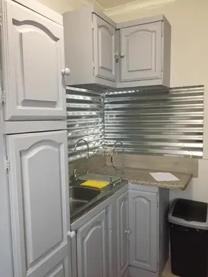 a kitchen with white cabinets and a sink at Burgersfort Gastehuis in Burgersfort