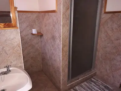 a bathroom with a shower and a sink at Burgersfort Gastehuis in Burgersfort