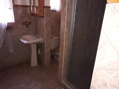 a bathroom with a sink and a toilet at Burgersfort Gastehuis in Burgersfort