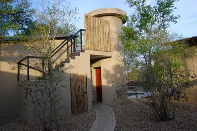 a house with a round window and a wooden door at Ngalas Rest 101 in Hectorspruit