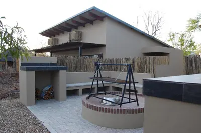 a house with a bench in front of it at Ngalas Rest 101 in Hectorspruit