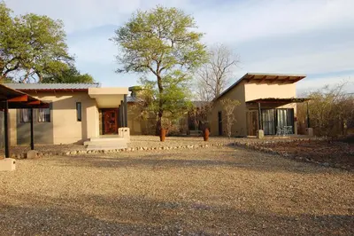 a house with a gravel driveway in front of it at Ngalas Rest 101 in Hectorspruit
